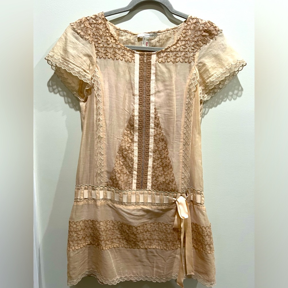 Cream drop waist dress with lace details and a ribbon belt. Embroidery